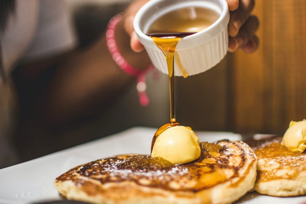 woman pouring sugar free syrup