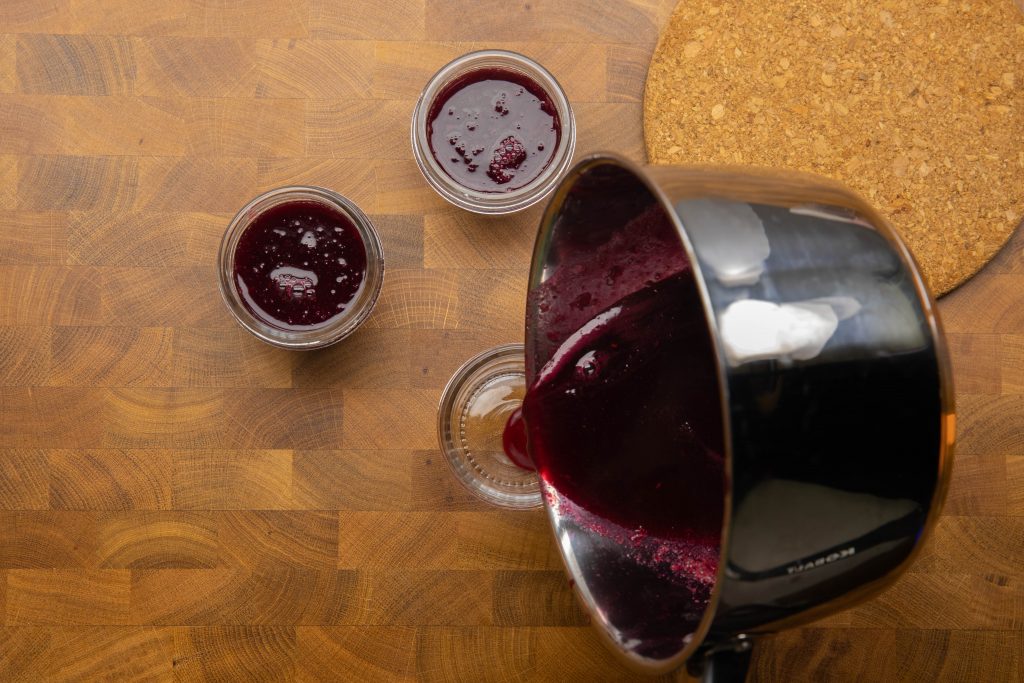 Pouring jelly mixture into jars