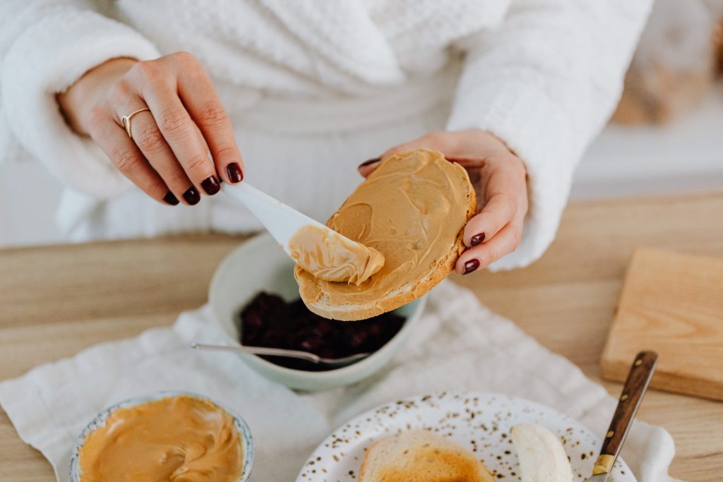 woman eating bread with peanut butter