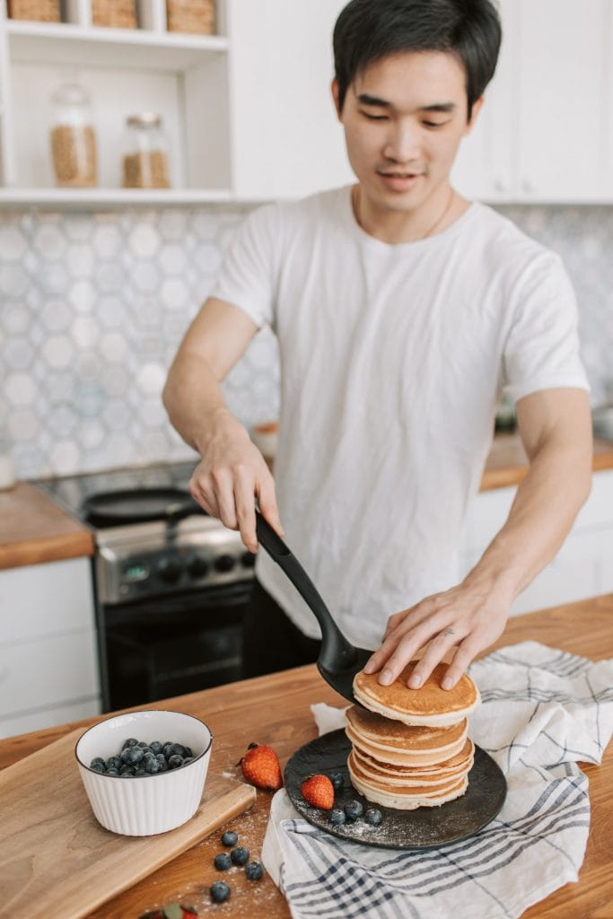 man cooking pancakes