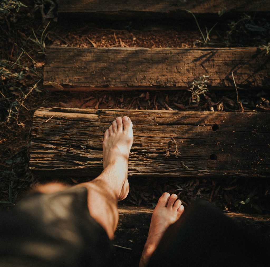 man standing on wood plank