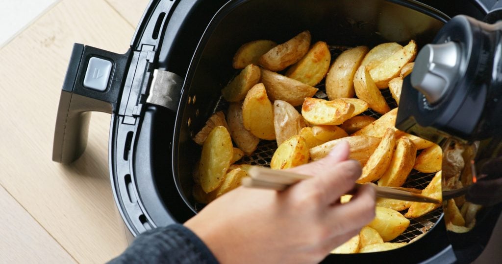 best oil for air fryer woman cooking with air fryer