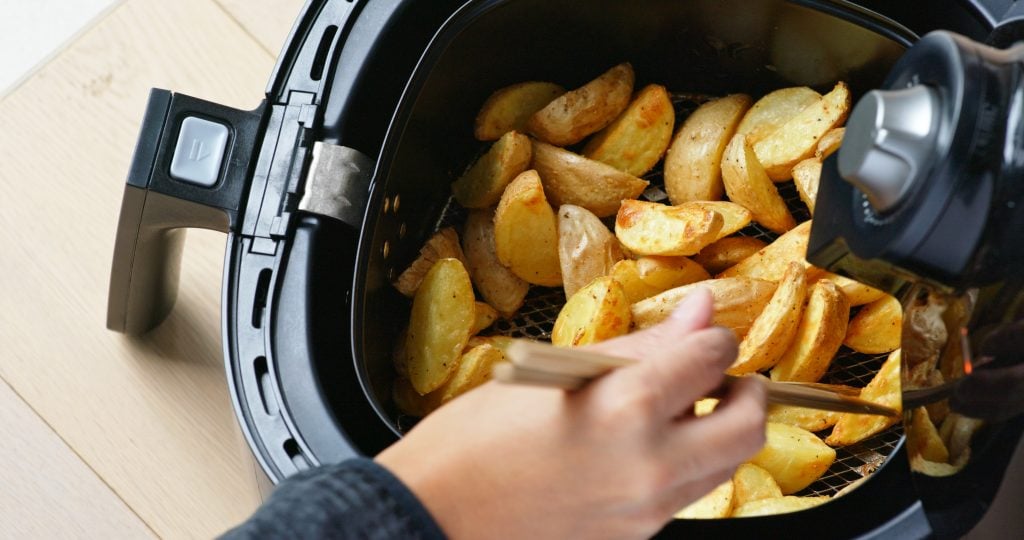 woman cooking with air fryer