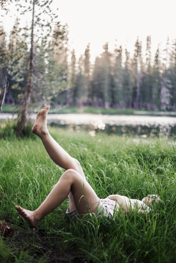 woman laying down on grass