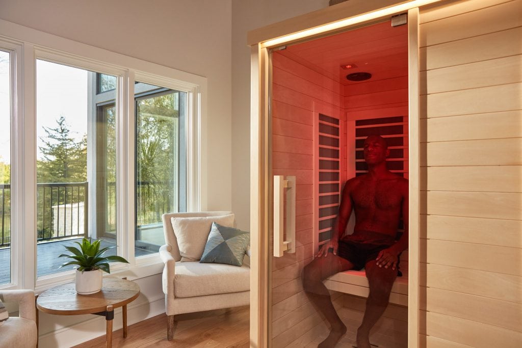 infrared sauna benefits man sitting at infrared sauna at home