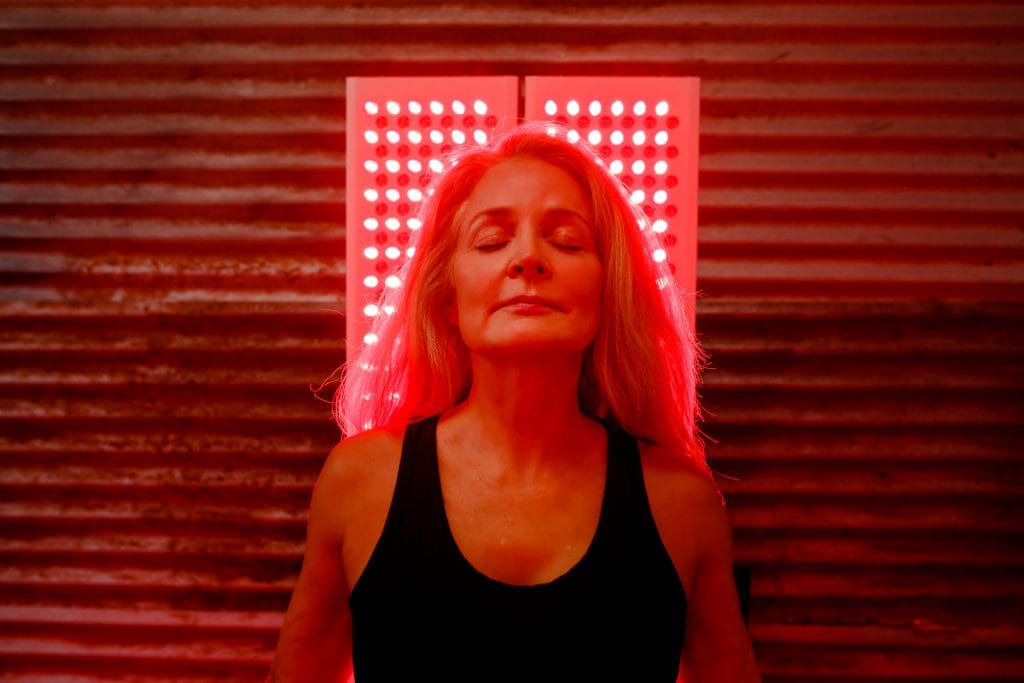 woman doing red light therapy at home