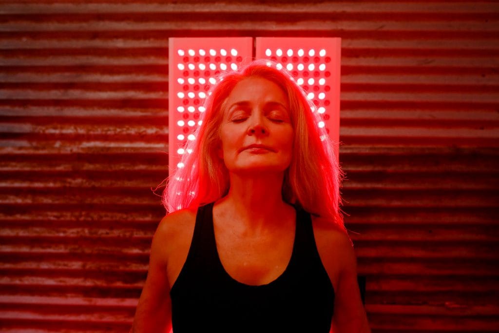how often should you do red light therapy woman doing red light therapy at home