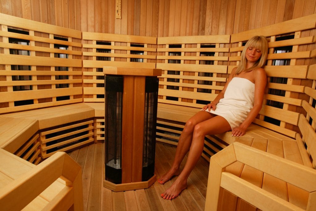 woman enjoying infrared sauna