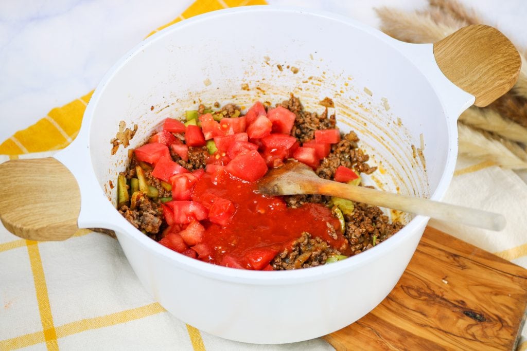 keto taco soup Adding tomato and tomato sauce