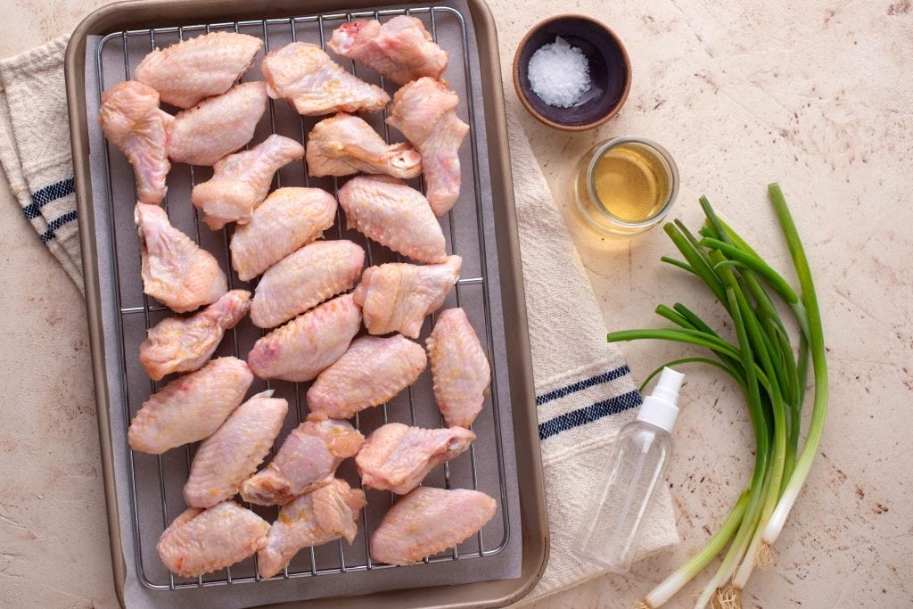Marinated chicken wings on a baking pan