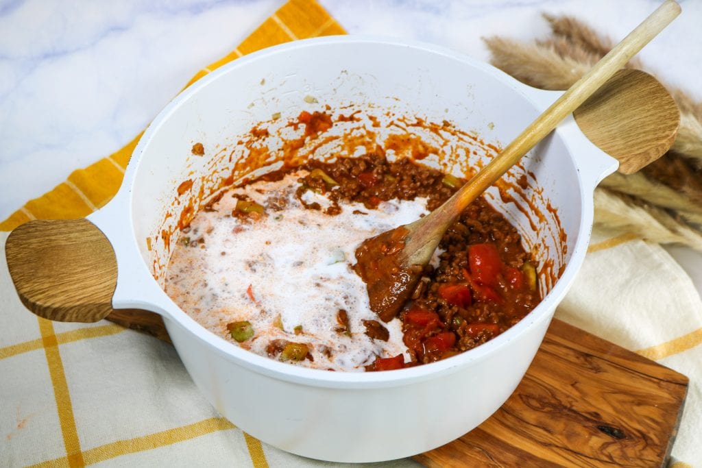 keto taco soup Pouring in liquid ingredients