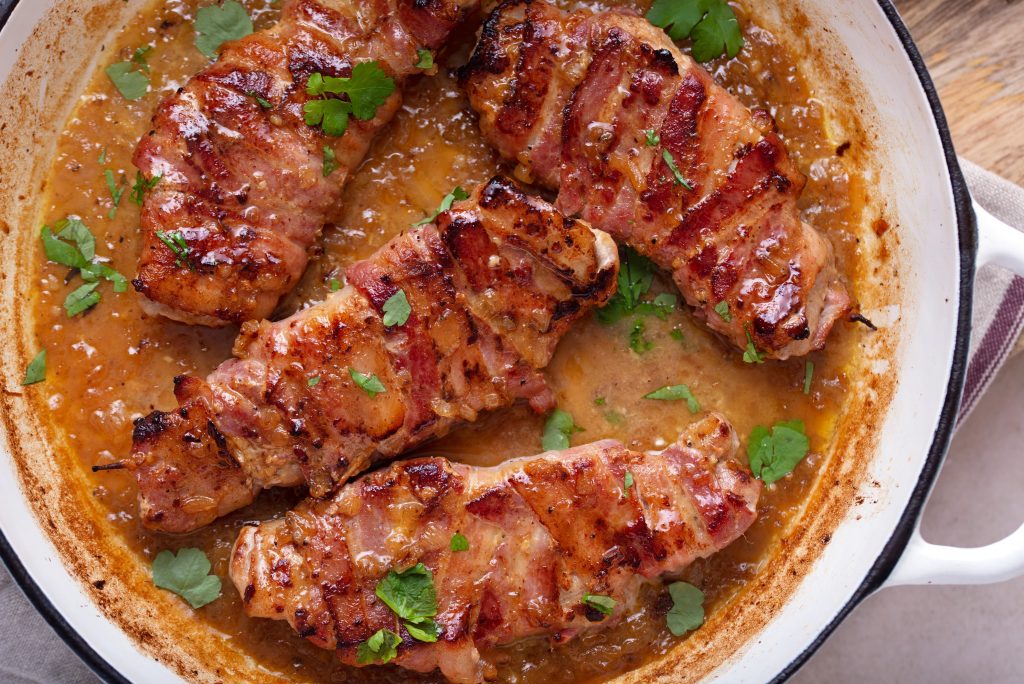 bacon wrapped pork chops Garnishing with flat leaf parsley