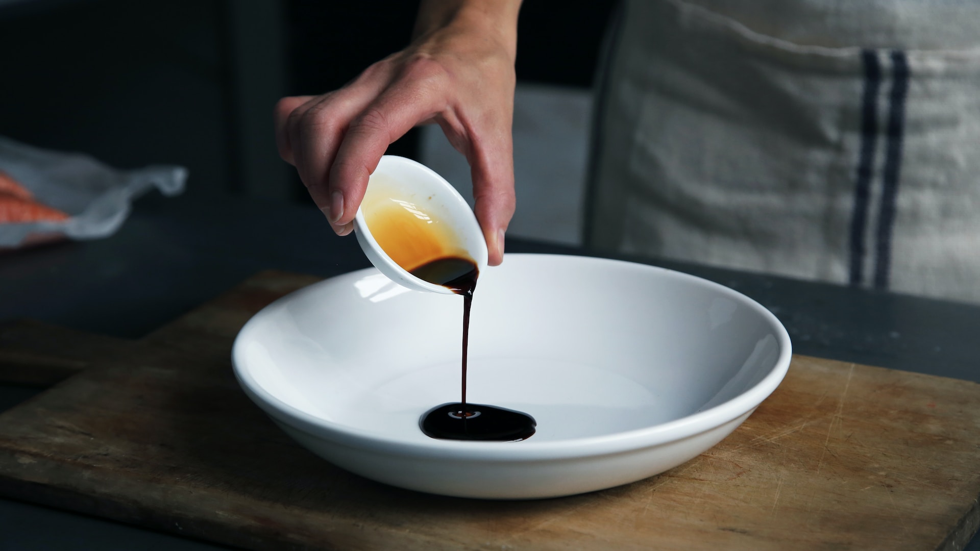 soy sauce dripping into bowl